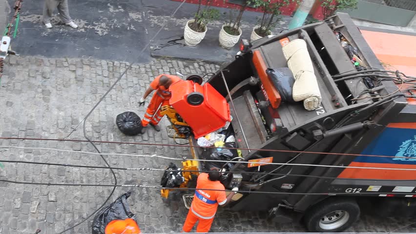 RIO DE JANEIRO, BRAZIL - JUNE 22: Municipal workers collect garbage, Rio de Janeiro, Brazil June 22, 2011. In 2008 the federal government began the work of slum upgrading and sanitation in an effort to mitigate problems afflicting Rio's poorest regions.