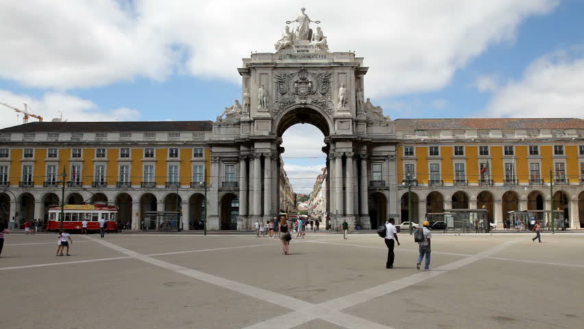 People walking on the Commerce Square (Praca do Comercio) in downtown Lisbon, near the Tagus river. The square was completely remodelled after the earthquake in 1755.