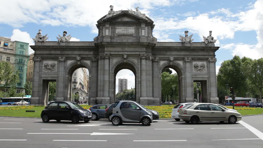 MADRID - APRIL 22, 2011: Midday traffic in front of the Alcala Gate (Puerta de Alcala) in Madrid, Spain. The Alcala Gate is a famous landmark in downtown Madrid.