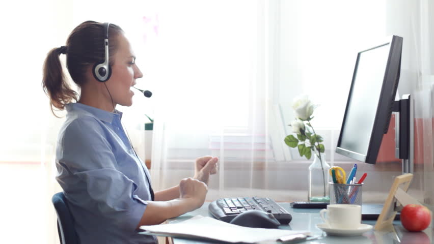 Attractive helpdesk consultant smiling to the camera