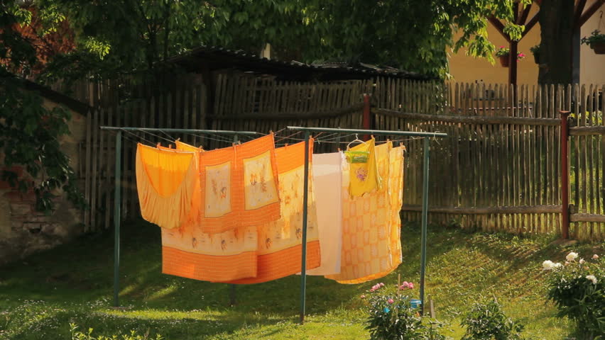 Washed clothes drying outside of an old house