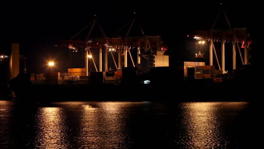 Port warehouse with cargoes and containers at night. Odessa, Ukraine 