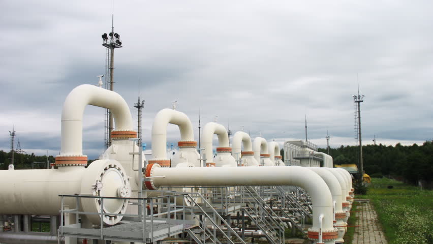 clouds move over installations cleaning gas main pipeline, time-lapse
