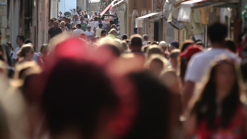 Crowd, unrecognizable people. Tourists walking in a narrow street in Porec, Croatia. 