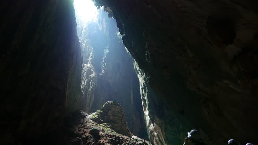 Bright Grotto Ceiling Opening, Dark Walls And Narrow Passage, High ...