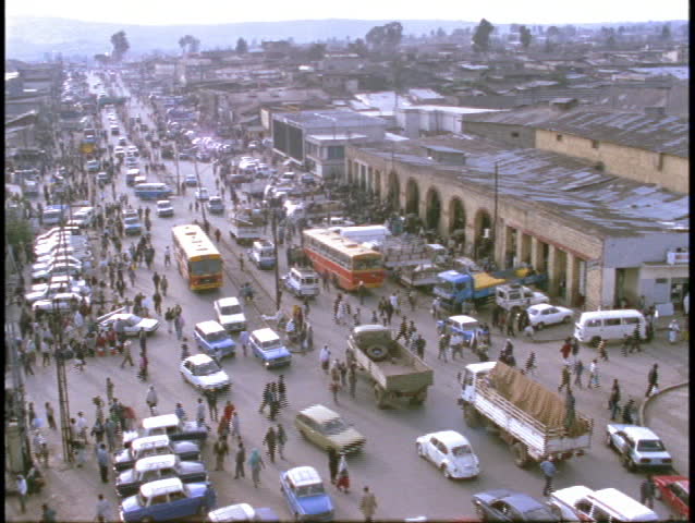 Pedestrians and vehicles crowd a street in Somalia.