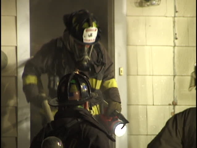 firemen exit burning house
