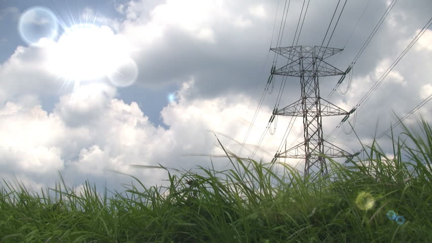 Electricity pylon with sun and green grass