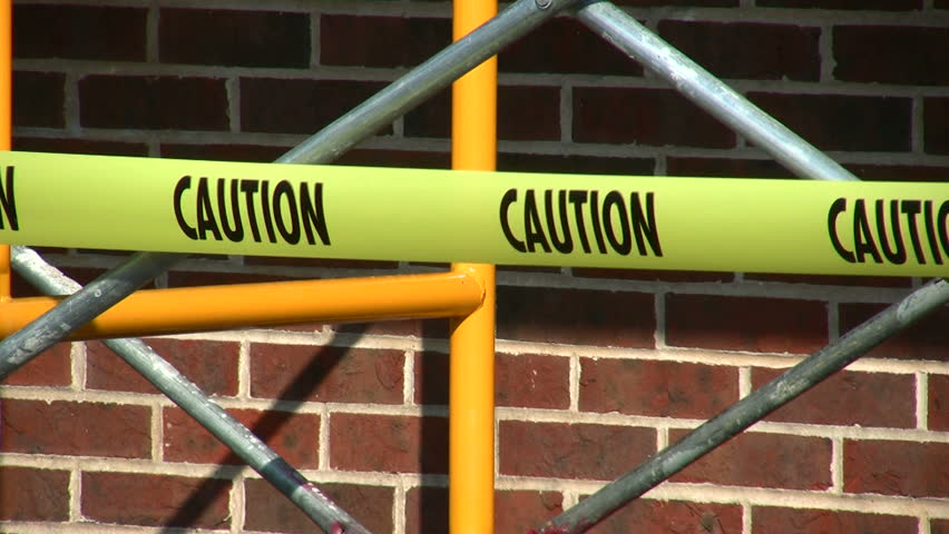 caution tape against a building 