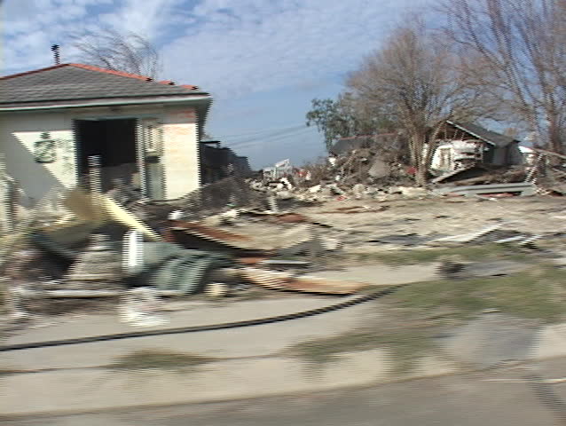 Rubble and debris has been piled on the side of the road shows the destruction caused by Hurricane Katrina.