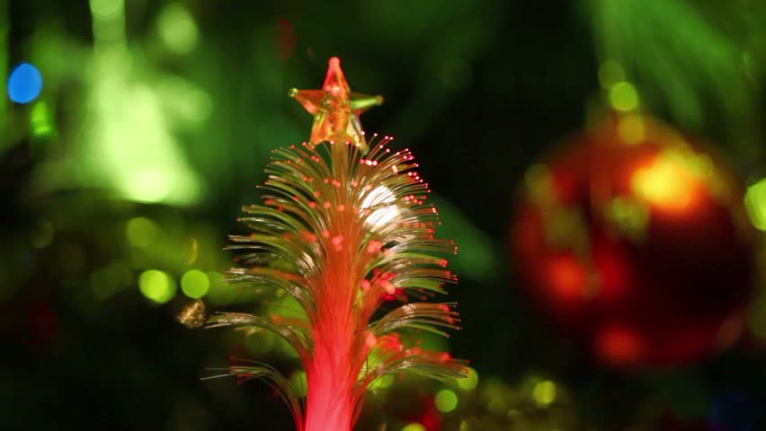 Illuminated souvenir as conifer with star, christmas tree ornaments, red ball, garland
