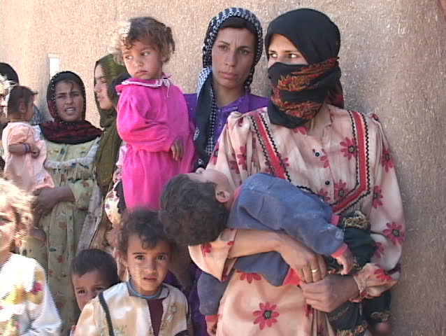 IRAQ - CIRCA 2003: Women and children wait to get into a rural  medical clinic circa 2003 in Iraq.