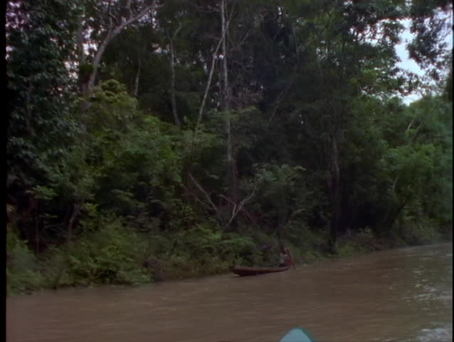 Native Americans Paddling Down River On Canoe Stock