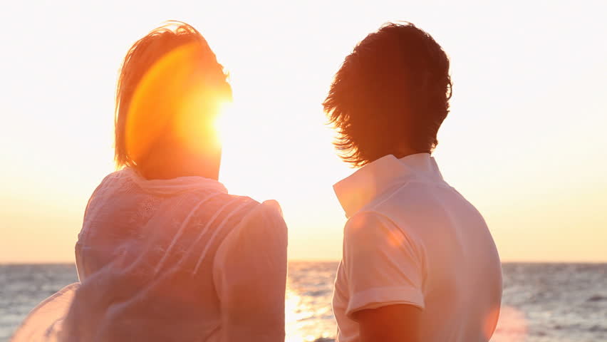 happy couple watching the sunset