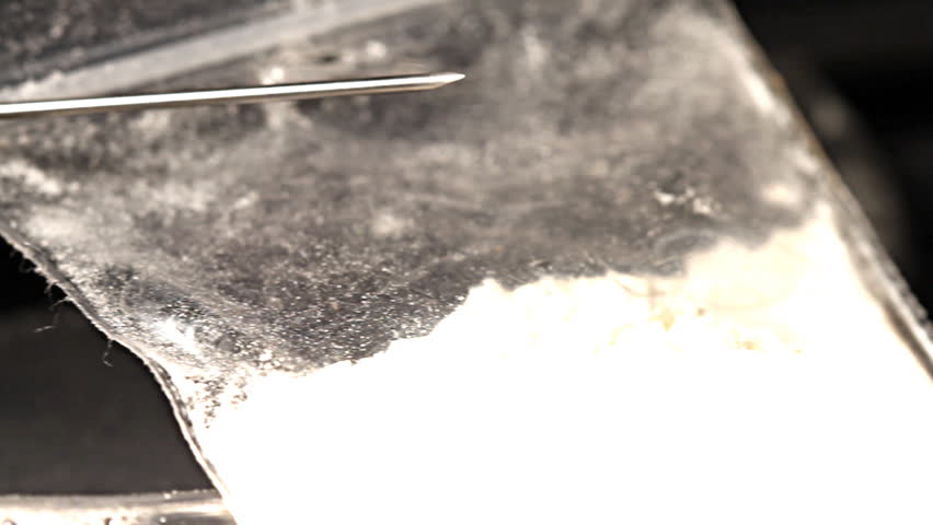 Hard drug - addiction concept. ILLUSTRATION! The white powder is flour before anyone think something else :-)  Studio setup with professional lighting and dolly motion.
