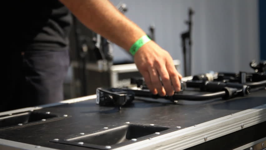 CU of men picking up music equipment