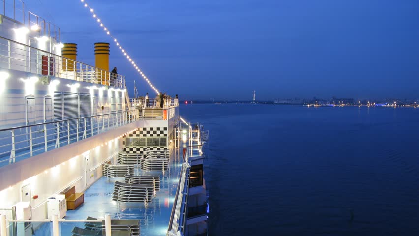 Cruise liner leaves Saint Petersburg at night, view from ship deck, time lapse