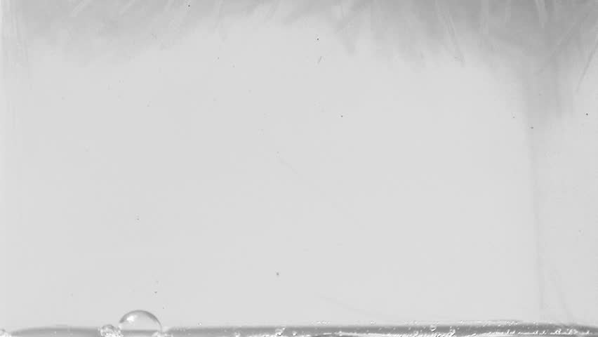 Water freezing into ice on window