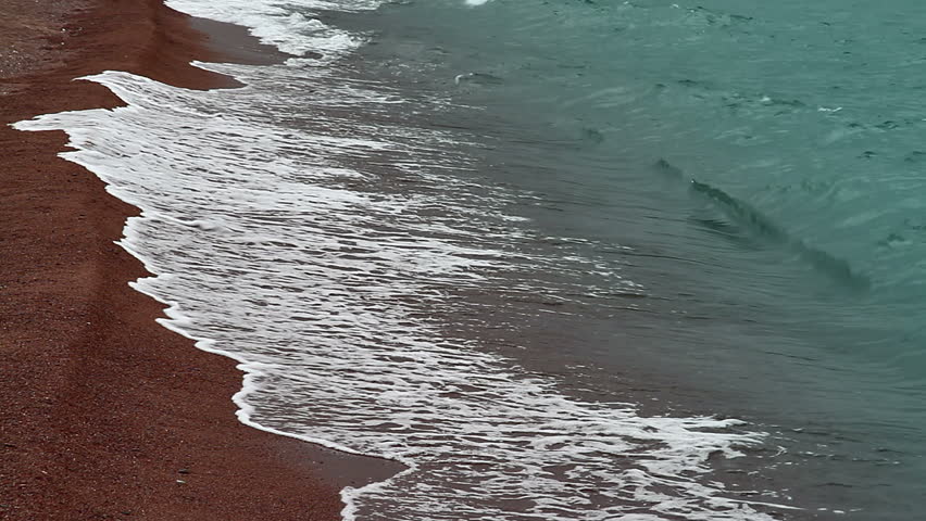 Bright terracotta sand and clear water