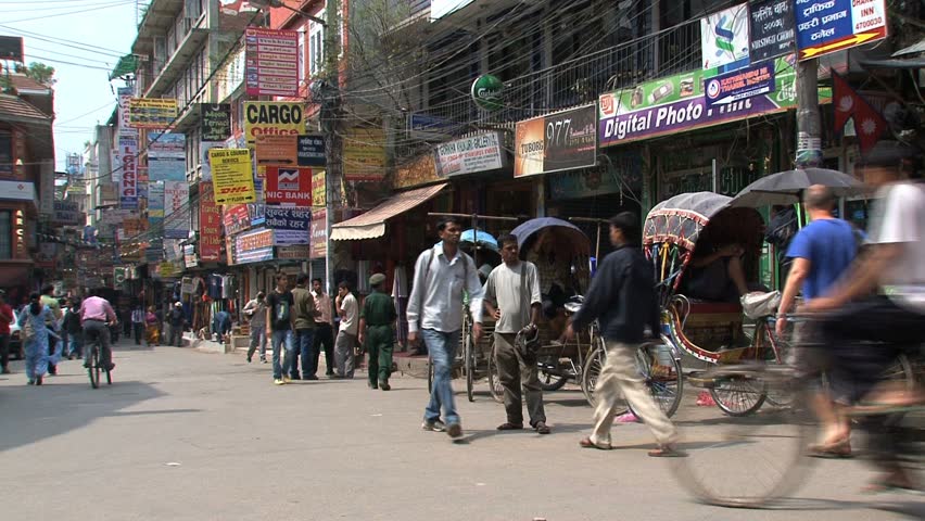 KATHMANDU - CIRCA 2010: People, cars and bikes circulate through the city circa 2010 in Kathmandu.