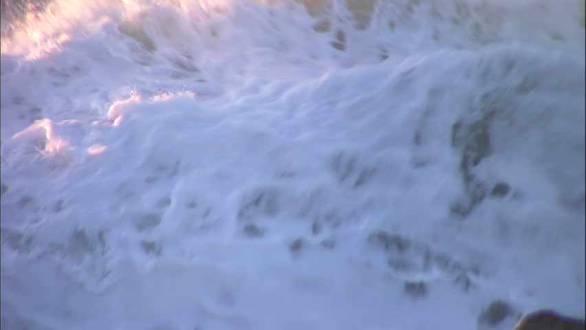 Wild Ocean Golden Foam Flying Pull to Reveal Rugged Coastline Slow-motion Pull