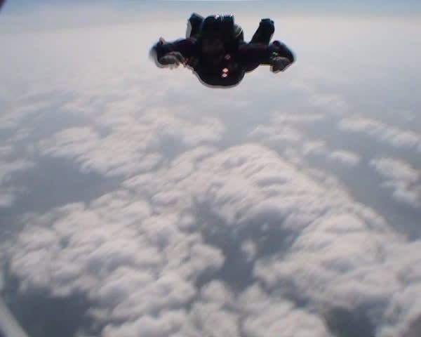 Skydiver flies past camera man