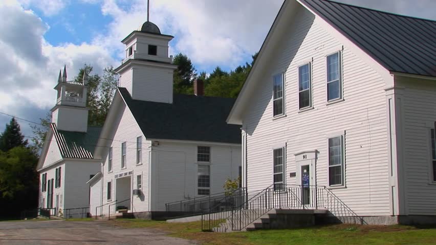 Trees surround three historic buildings at a New England, Maine town.