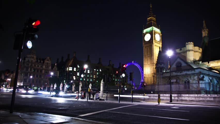 WESTMINSTER, LONDON - CIRCA JULY 2011 - (Timelapse View) Big Ben and London Eye at night as traffic and people zip by circa July 2011 in London.