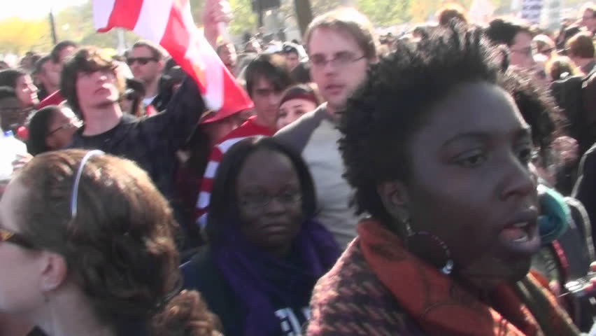 WASHINGTON, DC - CIRCA 2010: A man holds up an American flag with a peace sign on it at a political rally circa 2010 in Washington DC.