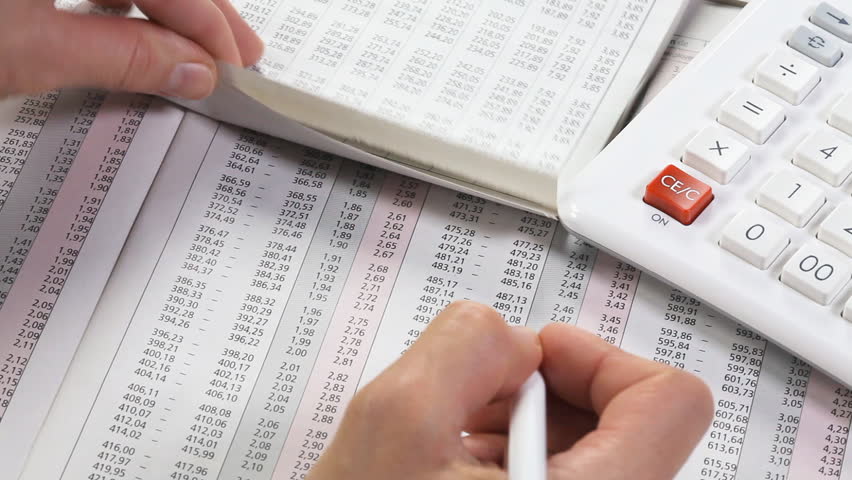 Accounting. Business woman working with a calculator and documents.  