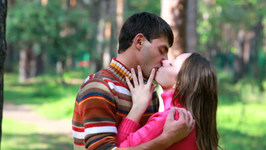 Young passionate couple kissing outdoors 