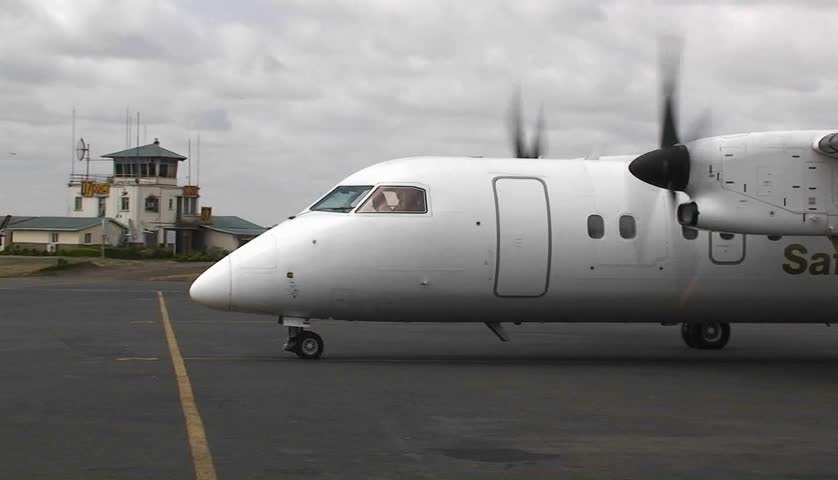 Twin engine prop-plane on airport tarmac.