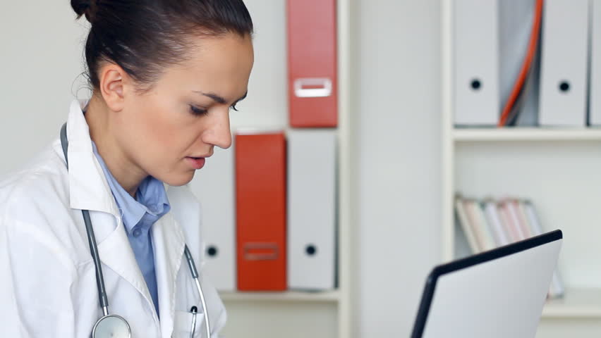 Young female doctor with with migraine headache 
