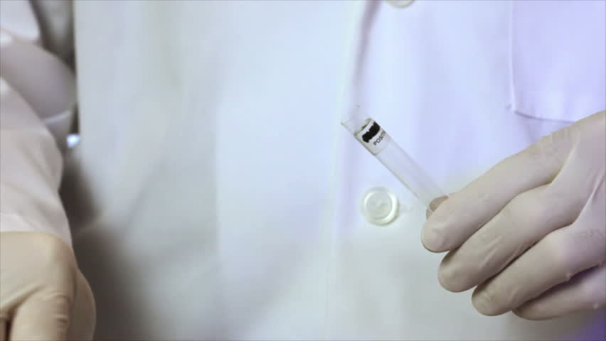 A laboratory technician or crime scene investigator using a method to determine if blood is present on a swab sample observes the chemical reaction.