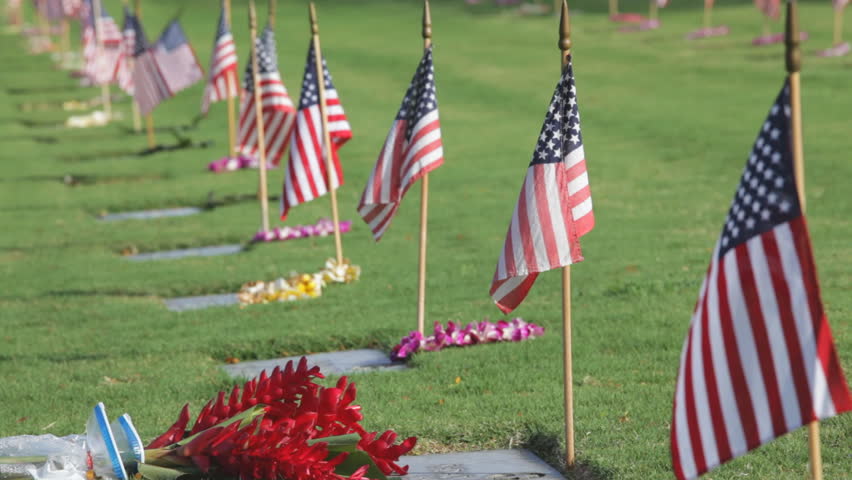 Locked down clip on Memorial Day in Punchbowl National Cemetery (aka National Memorial Cemetery of the Pacific). Each of the approximately 38,000 graves are adorned with a small US flag and a lei.