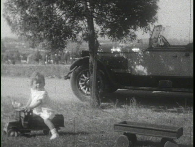 CALIFORNIA, USA - CIRCA 1920s: People drive cars and have a picnic in a home video circa 1920s in California.