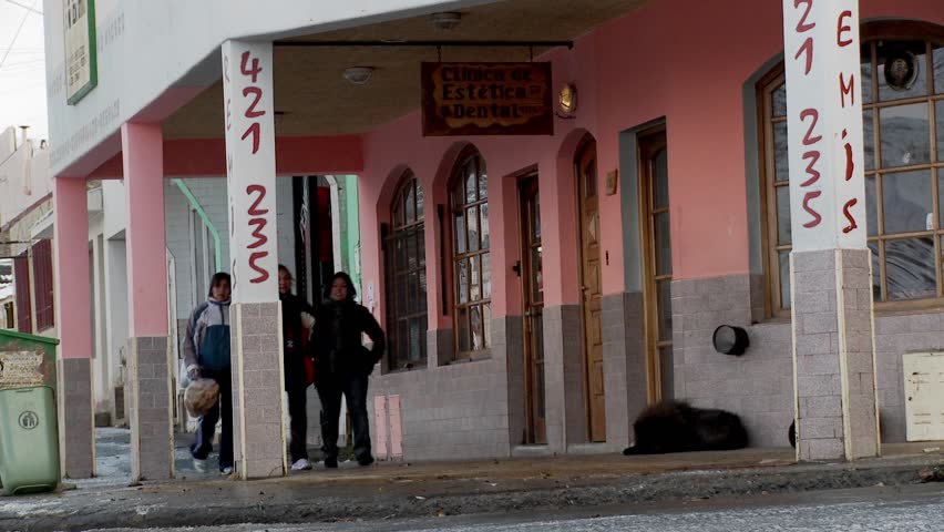 PATAGONIA, SOUTH AMERICA - CIRCA 2009: People walk on the streets of an Argentina or Chile town in winter circa 2009 in Patagonia, South America.