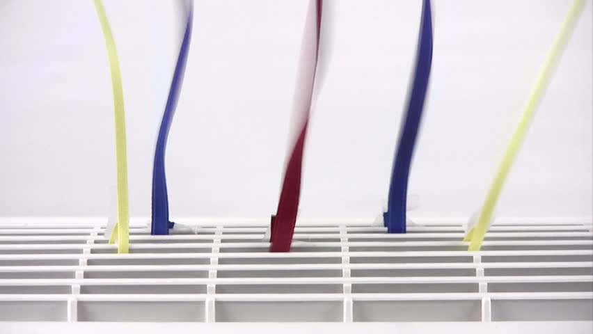 Close up of an air purifier with colorful streamers attached.