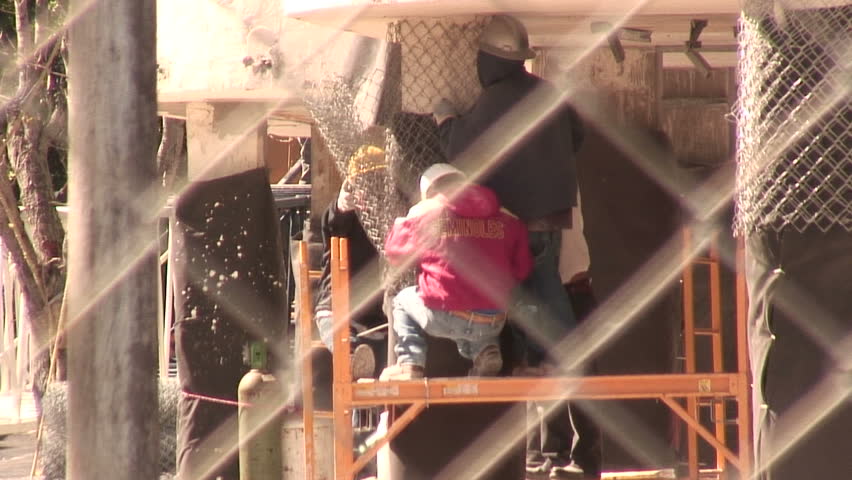 WEST PALM BEACH,  FL - FEB 13:  Workers begin clean up at the Flagler condo site after the implosion on February 13, 2010 In West Palm Beach, Florida. 