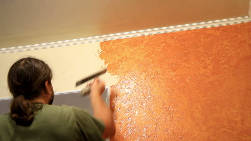 Master applies colored wax on ornamental plaster. 
