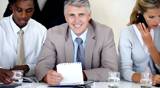 Confident male leader with multi ethnic team giving you thumbs up in meeting
