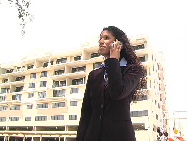 A beautiful Latina brunette reviews modeling photos with her caller on a futuristic cell phone.