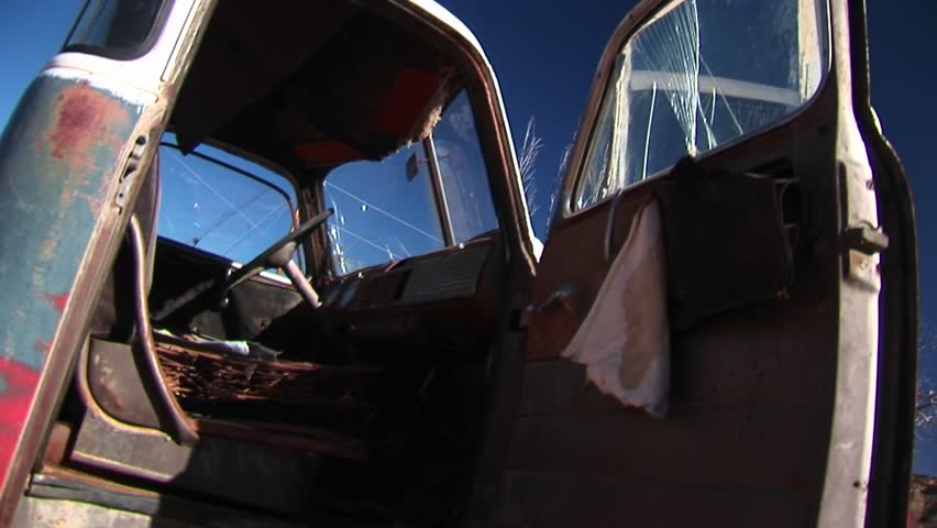 Medium close-up inside the cab of broken-down pickup truck discarded in the Utah desert.