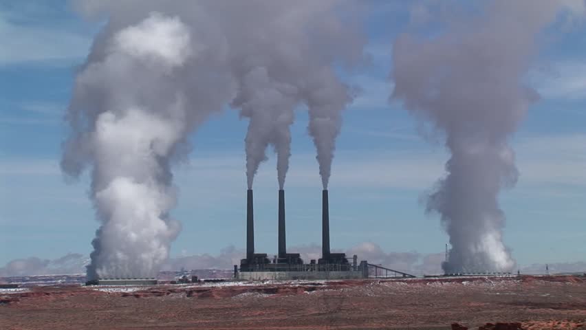 Factory in the Arizona desert, belching polluting fumes into the air.