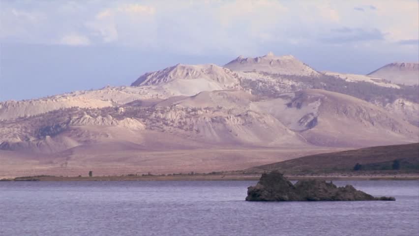 Birds soar over Mono Lake with the extinct volcano in the background