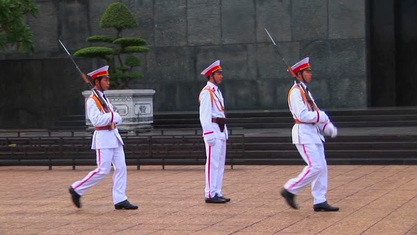 HANOI, VIETNAM - CIRCA 2010: Vietnamese guards walk in front of the tomb of Ho Chi Minh.