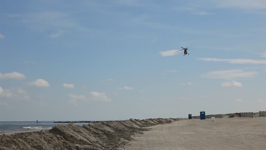 A rescue helicopter soars over Louisiana coastline