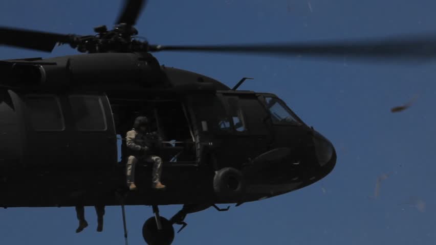 An emergency helicopter soars over contaminated gulf
