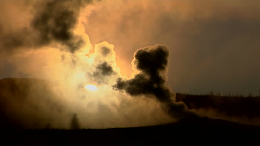 Dark clouds rise from a volcanic eruption in a geothermal area of Yellowstone National Park