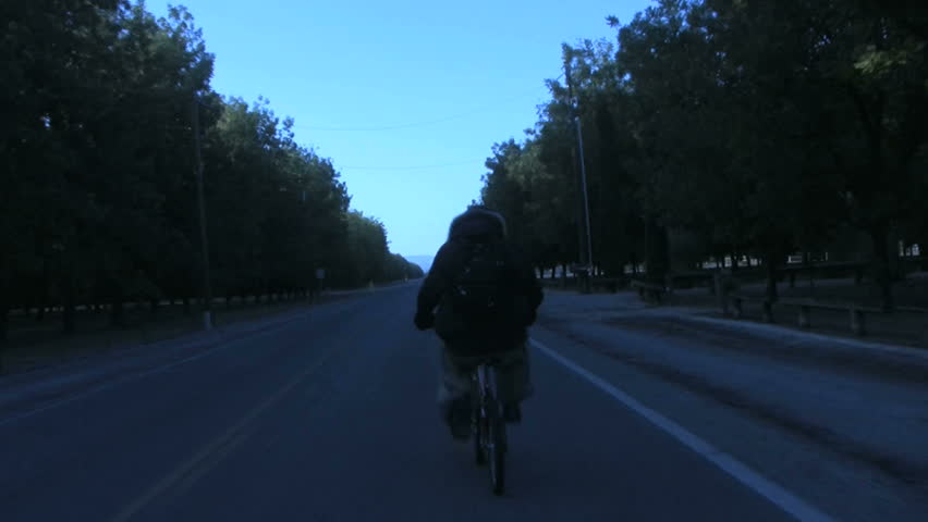 Biking down a road in a cold day